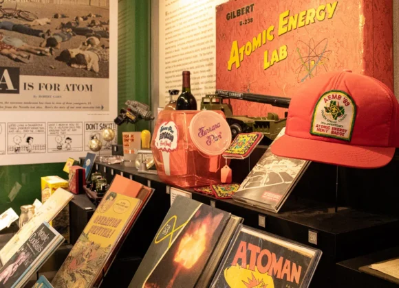 Vintage atomic-themed pop culture memorabilia, comic books, and a red hat on display.