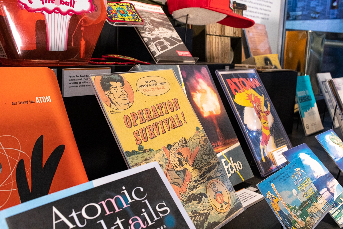 Close-up display of atomic culture artifacts, comic books, and vintage publications.