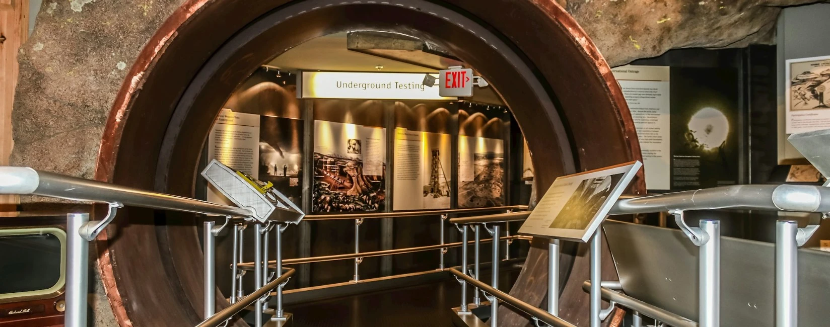 Underground Testing exhibition with displays inside a circular tunnel.