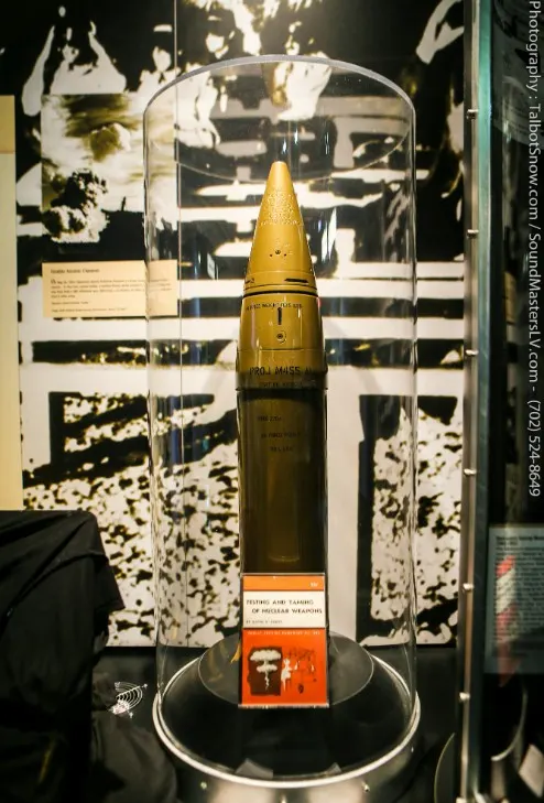 Artillery shell in a glass display case at a museum.