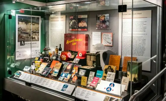 Vintage atomic-themed pop culture memorabilia, comic books, and a red hat on display.
